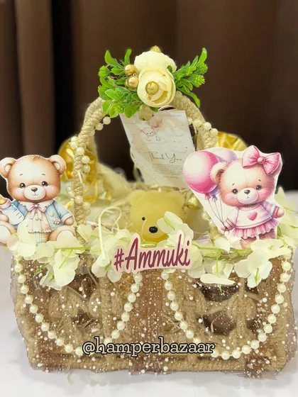 A rustic and charming jute hamper for baby Ammuki, decorated with teddy bears, pearls, and flowers.