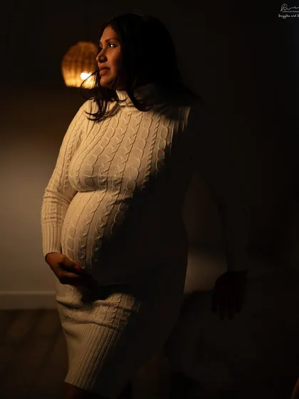 Using warm, low light to create a cozy and intimate mood. The cable-knit dress adds texture to this beautiful low-key portrait.
