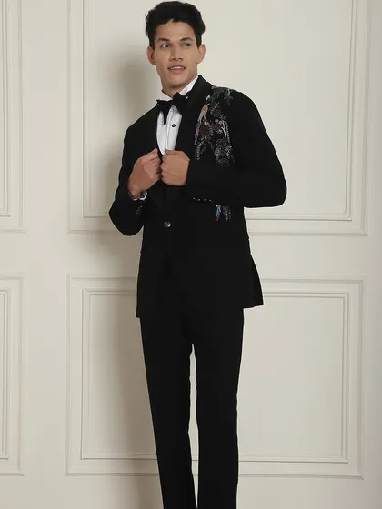 A black tuxedo with stunning, colorful bird embroidery on the shoulder. This is a true designer piece for the man who wants his outfit to be a work of art.