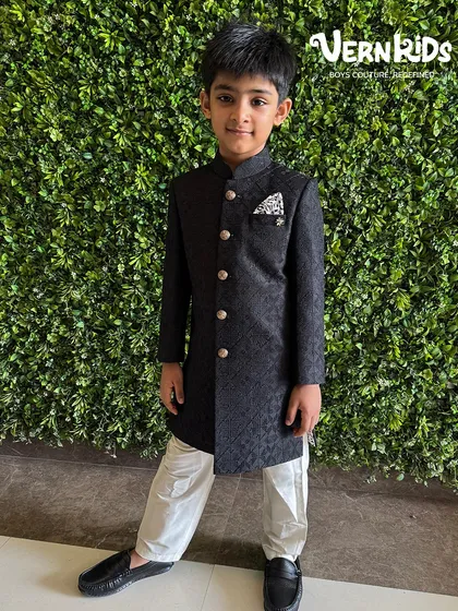 He walked in and stole the show. This is what main character energy looks like in our classic black sherwani, designed to make little boys shine.