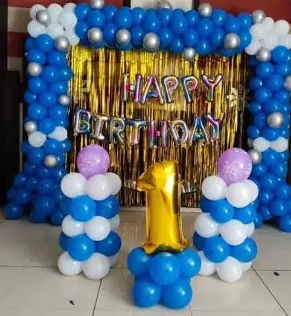 A simple blue, white, and silver balloon setup with pillars and a 'Happy Birthday' foil banner.