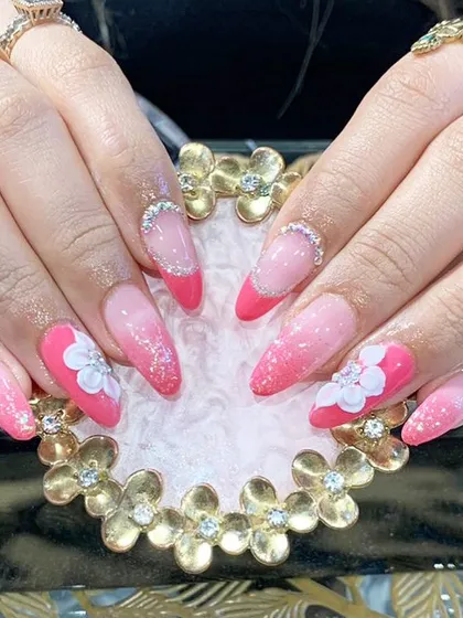 A vibrant pink ombre and French tip combination design, beautifully accented with white 3D flowers.