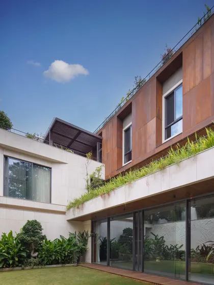 The facade of a home should be experienced from within, not just admired from the street. For this large residence, I used a dual-tone palette of French Beige marble and rust-finished boards to create a dynamic visual experience from every vantage point.