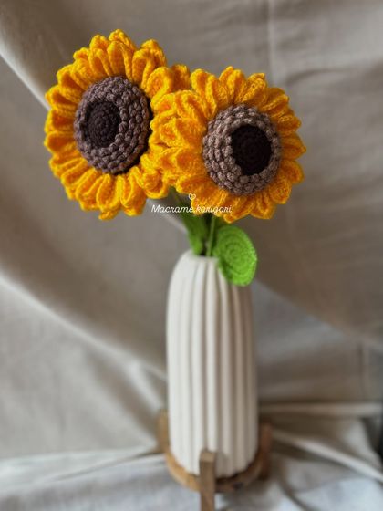 Two crochet sunflowers standing tall in a simple white vase. This minimalist styling shows how just a couple of stems can add a beautiful touch to your decor.