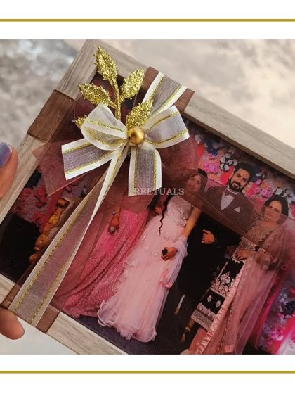 A personalized photo frame wrapped with a beautiful ribbon, part of a curated birthday hamper.