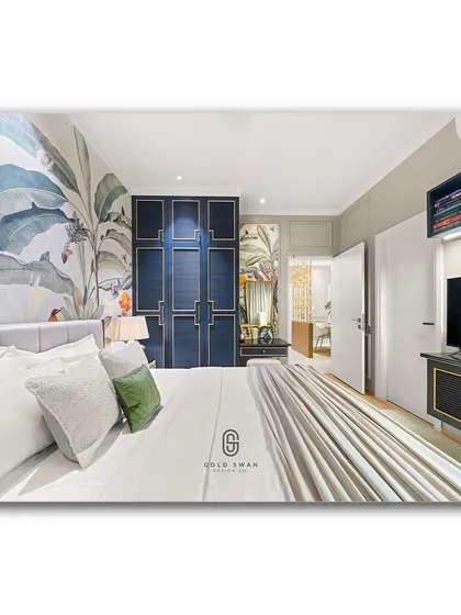 A wide shot of a bedroom featuring a stunning tropical wallpaper and a deep blue, panelled wardrobe. The combination of bold color, intricate patterns, and clean lines creates a space that is both luxurious and full of personality.
