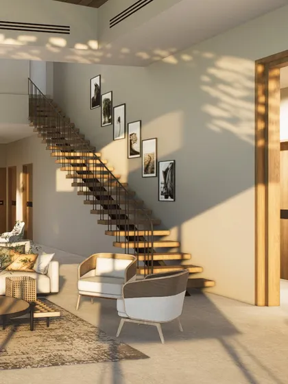 The living area of this Kangra holiday home is designed to be open and airy, with a floating staircase that adds an architectural element without obstructing the view. The palette is warm and minimal.