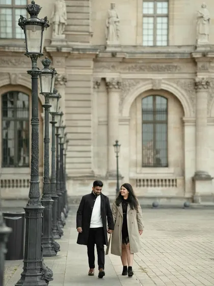 A happy, candid moment of a couple walking through Paris. Their genuine smiles and the beautiful architecture in the background make this a perfect snapshot of their love story.