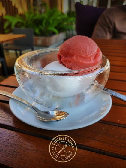 A refreshing scoop of strawberry and lemon sorbet served in a thick glass bowl. A perfect light dessert or palate cleanser.