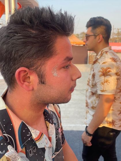 A simple patch of silver glitter on the cheek. It's an easy and cool way to add some festival flair to your look.