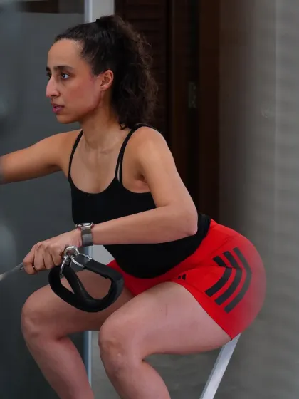 Wellness begins the moment you choose to move. This image captures the intensity and focus of a deep squat, a movement that connects breath, body, and mind in perfect harmony.