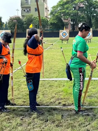 Archers from different teams wait for their turn on the shooting line. The archery community is built on mutual respect and a shared passion for the sport.