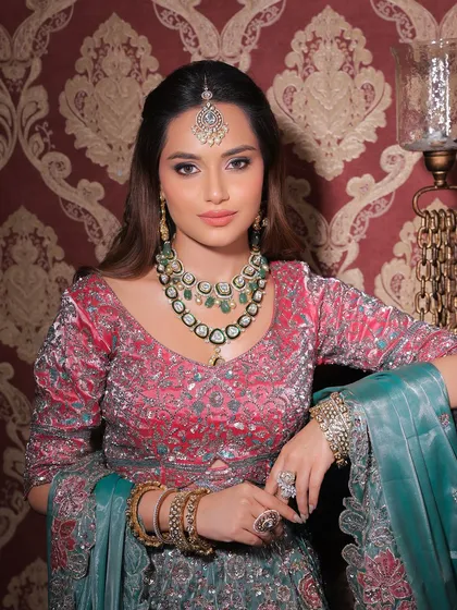 A regal and poised look. The makeup is flawless, complementing the intricate jewellery and stunning outfit perfectly.
