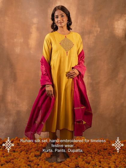 Our Ruhani silk set, featuring the yellow pleated kurta, matching pants, and a contrasting pink dupatta. This complete hand-embroidered outfit is designed for timeless festive wear, ready for any celebration.
