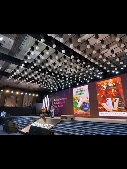 A speaker on the large stage of the VIVO V60e Partners’ Conclave during the business summit.