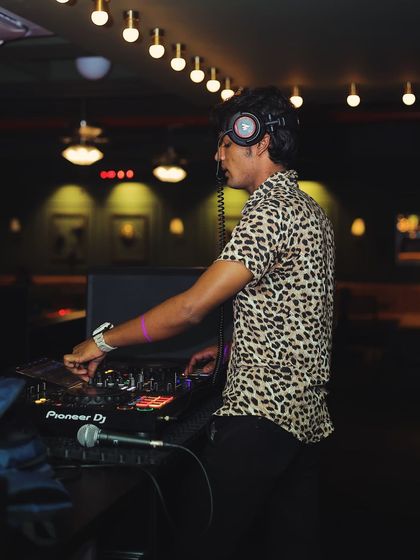 The energy of the crowd fuels my passion. A shot of me with headphones on, cueing up the next track.