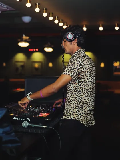 The energy of the crowd fuels my passion. A shot of me with headphones on, cueing up the next track.