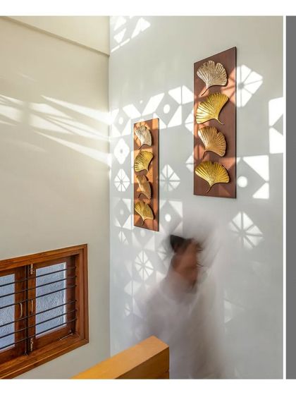 A beautiful play of patterns created by light filtering through a jali screen onto the staircase wall.