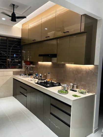A real-life look at one of our completed kitchens. The glossy brown cabinets and white quartz countertop create a warm and inviting space, ready for daily cooking.