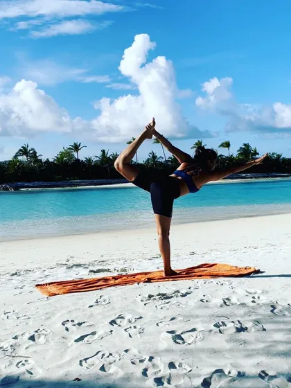 Finding balance and grace on a pristine white sand beach. This is Natarajasana, the Lord of the Dance pose, embodying the dynamic stillness we cultivate in our practice, surrounded by the beauty of the Maldives.
