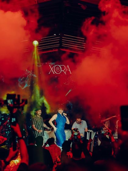 A dynamic shot of a celebrity DJ on stage, used for promoting an upcoming event. Action shots from previous events serve as powerful social proof in my promotional graphics.