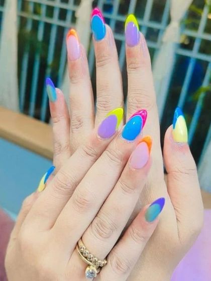 A creative take on French tips with a multi-color gradient on each nail. This design is vibrant, artistic, and perfect for those who love color.