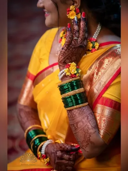 A happy bride during her haldi ceremony, her hands adorned with my mehndi and floral jewelry. The dark stain looks beautiful against the yellow of her outfit.
