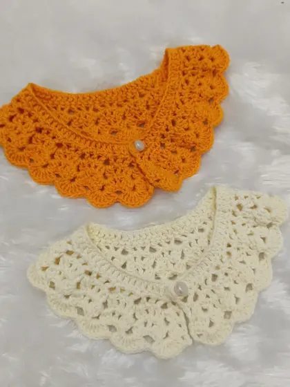 My detachable collars are a simple way to add charm to any outfit. Here you can see two different lacy styles in orange and cream, each with a delicate pearl button closure, ready to be paired with a simple top or dress.