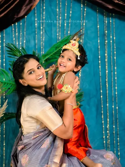 A mother holds her son, who is dressed as Little Krishna for Janmashtami. I love creating themed photoshoots for festivals to celebrate our culture and create unique memories.