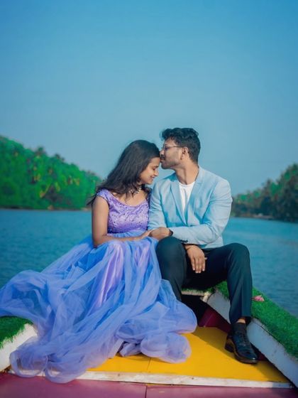 A sweet and tender moment during a pre-wedding boat ride. The lavender-blue gown is a soft and romantic choice for a photoshoot on the water.