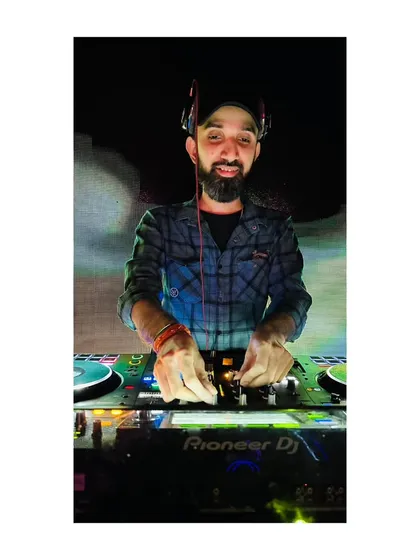A straight-on shot from the DJ booth, showing my hands on the Pioneer DJ mixer. This is where the magic happens.