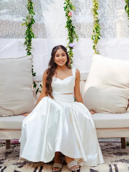 Yogini looking fresh and modern in a white co-ord set for a pre-wedding event. The makeup is minimal and clean, perfect for a chic, daytime look.