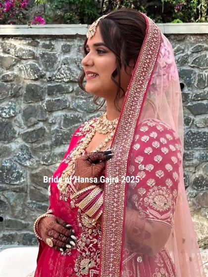 A side profile of a radiant bride. Her elegant pose showcases her beautiful mehendi, hair, and makeup, all coming together for a timeless bridal look.