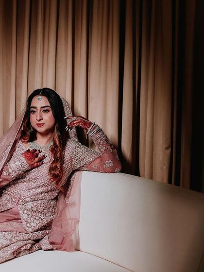 A duplicate of ID 282, this portrait captures a Muslim bride's elegant pose on a white couch.