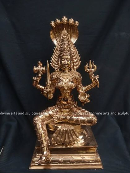 A finished bronze sculpture of Mariamman, her five-headed serpent hood rising above her. This is a classic South Indian representation of the powerful goddess.