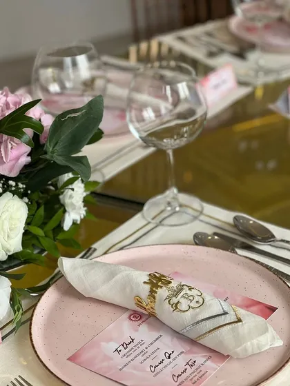 A customized table setting for a special occasion, featuring personalized menus and napkins, demonstrating our ability to tailor every detail to your event.
