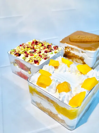 Another look at my cake tubs, highlighting the vibrant colors of the fresh mango and the delicate pink of the Rose Pista.