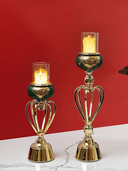 For a more modern look, these candle stands feature a unique heart-shaped metal frame in gold, paired with a deep green ceramic accent. They are a stylish and contemporary way to add candlelight to your home.