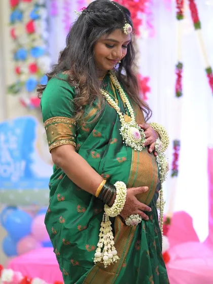 A simple yet stunning look for a baby shower. This set features a large central floral piece on the necklace, made with white and pink flowers to match her maang tikka.
