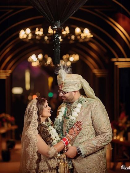 A beautiful bride and groom, with the bride's hair styled in soft, elegant waves.