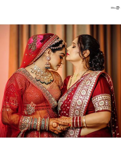 A touching moment between the bride and her mother. A gentle kiss on the forehead is a perfect expression of love and blessings.