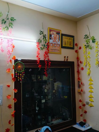 This image shows how I decorate around existing furniture and frames. The colorful hangings and vines bring a festive feel to the room for the Kalpasutra ceremony.