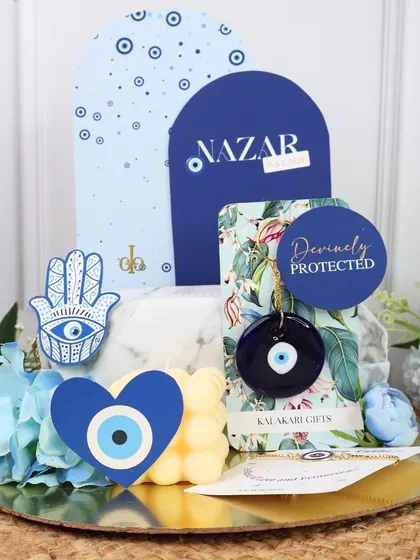 I love creating gifts that are both trendy and meaningful, like this Evil Eye themed Rakhi hamper. It’s designed to offer protection and good vibes, combining a bubble candle, a beautiful Rakhi, and other coordinated items on a golden platter, all centered around the popular Nazar theme.