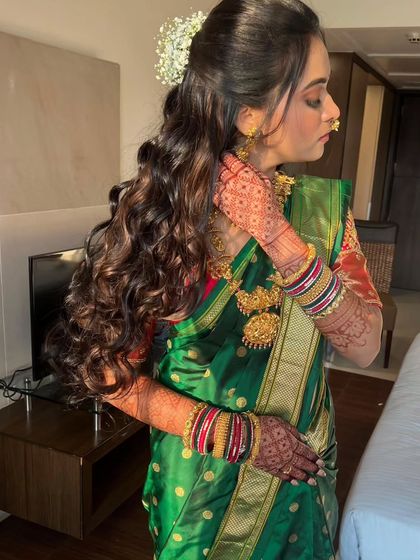 Another view of the beautiful long curls. I added a small gajra to the half updo for a touch of tradition.