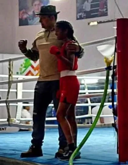 In the heat of a match, a coach's support is vital. Here I am in the corner with my student between rounds, offering encouragement and tactical advice for the next round of her boxing bout.