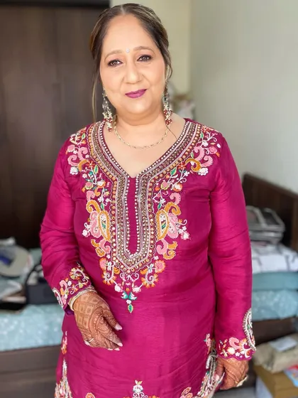 A mother's glow on her son's wedding day is truly special. I created a sophisticated look with a mauve lip and soft eye makeup that complemented her richly embroidered magenta suit.