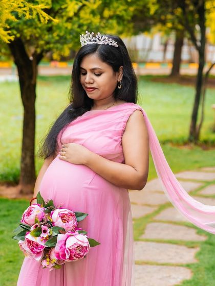 A portrait of grace and elegance. The mom-to-be wears a tiara and a beautiful pink gown from my client closet, creating a regal and memorable maternity photograph.