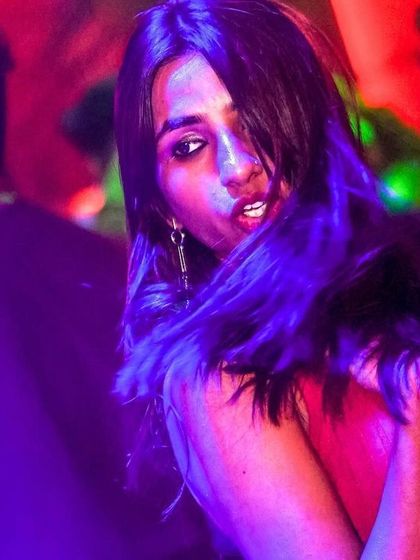 A dramatic, stylish shot of a guest on the dance floor, captured in the club's unique lighting.