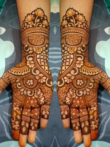 This full-hand design is rich with detail, featuring floral cuffs, intricate swirls, and leafy patterns that extend down to the fingertips.