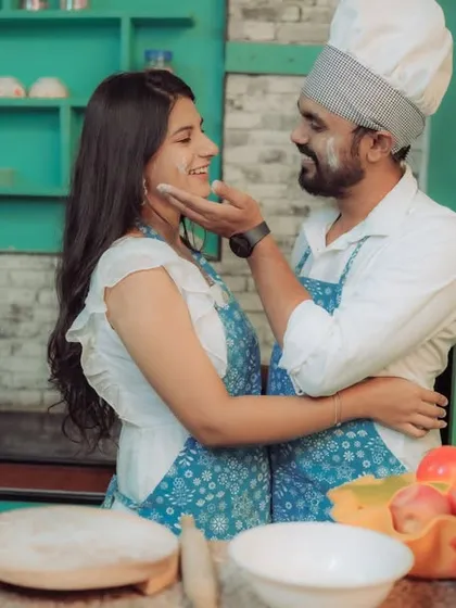 Love is cooking up something beautiful! This couple shares a laugh in a quirky kitchen setting, a perfect example of a themed pre-wedding shoot that reflects shared interests and creates fun, natural interactions.